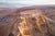 Masada Israel an aerial view of a desert with a mountain in the background